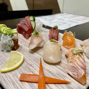 a variety of sushi on a cutting board