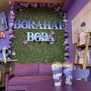 a living room with a purple couch and a coffee table