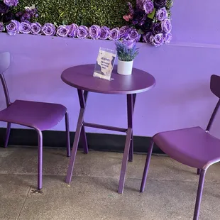 two purple chairs and a table