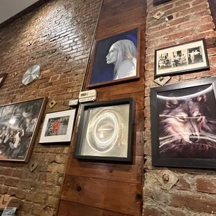 a brick wall with a lot of pictures on it