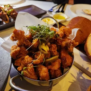 a bowl of fried food on a table