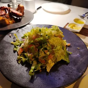 a plate of salad and a glass of wine