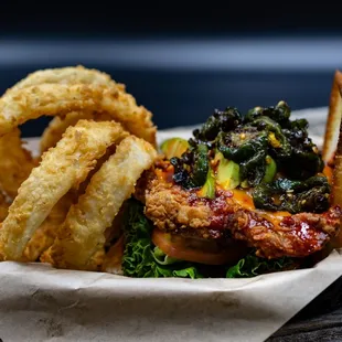 a burger with onion rings