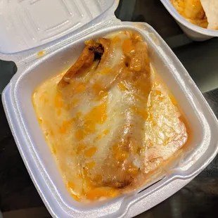 An abundance of cheese on the tamale side.