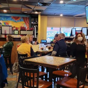 a group of people sitting at a bar