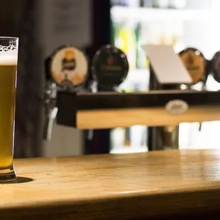 a pint of beer on a bar