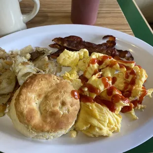 Three scrambled eggs, bacon, potatoes, biscuit. Yep ketchup on eggs, as my wife would say heathen lol.