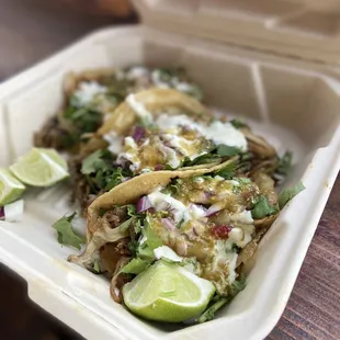 two tacos in a styrofoam container