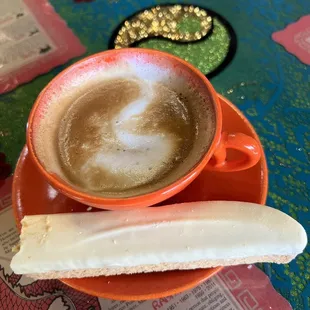 Lemon, almond biscotti with a cortado.