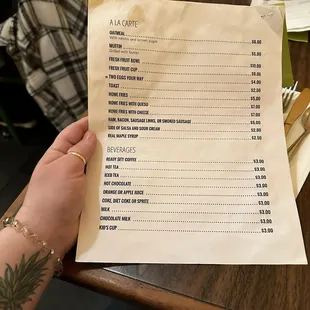 a hand holding a menu