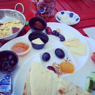 Trksh brekkie: jam, cheeses, pepper paste, eggs, sujuk sausage, olives, apricot, walnut, cucumber, grapes, tomatoes, pita, apple tea $14-16