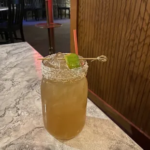 a drink in a glass on a table