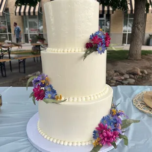 Larger reception cake. Last minute floral decorations added by Nicha!