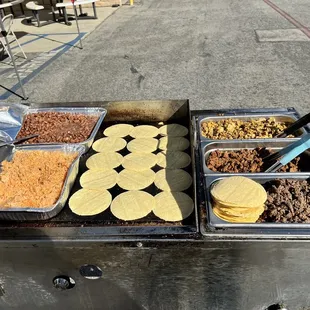 tacos being prepared on a grill
