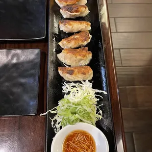 a plate of food with a glass of beer in the background