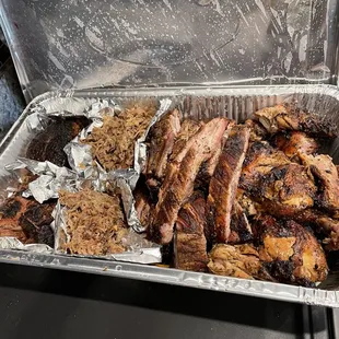 a tray of meat and ribs