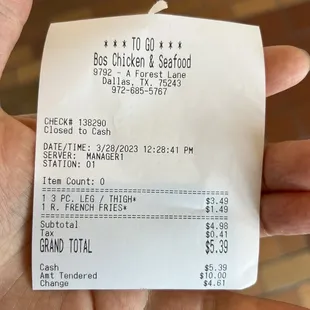 a hand holding a receipt