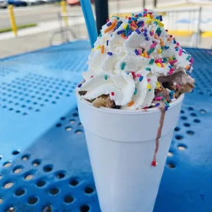 a cup of ice cream with sprinkles