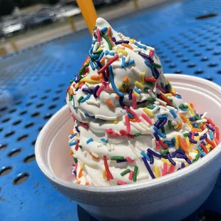 a cup of ice cream with sprinkles