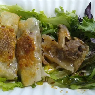 a plate of dumplings and a salad