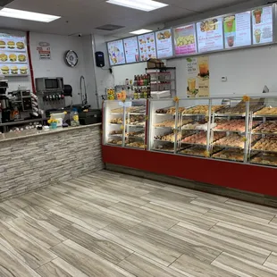 a bakery counter with a variety of donuts
