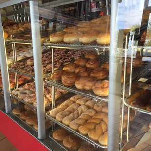 a variety of doughnuts in a display case