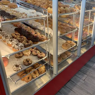 a variety of donuts in a display case
