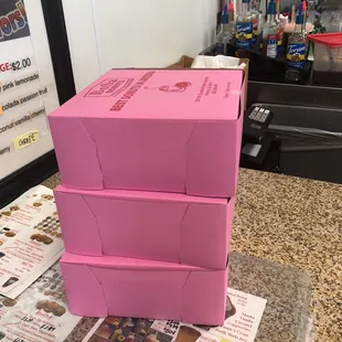 a stack of pink boxes