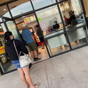 a woman standing in front of a store