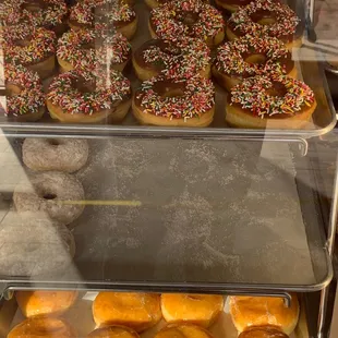 a variety of donuts in a display case