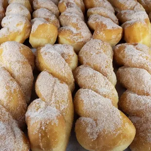 a pile of doughnuts covered in powdered sugar