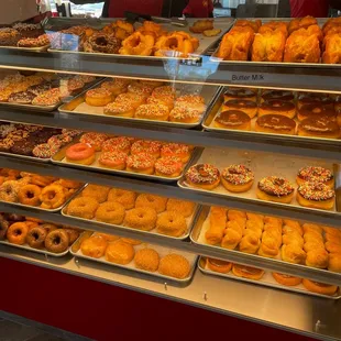 a variety of donuts in a display case