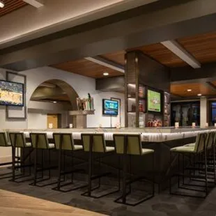 a bar with seating and tvs