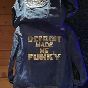 the back of a denim jacket that says detroit made me funky