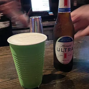 a beer and a green cup