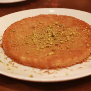 Kunefe! A golden and delicious cheese filled dessert, sweetened with simple syrup.