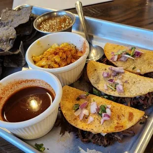Beef birria tacos, dipping sauce, elotes, chips &amp; salsa.