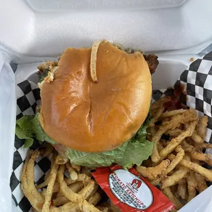 Mushroom Swiss burger with a side of onion strings. You have to ask for condiments because they do not put any on their burgers.