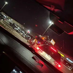 Cars waiting while employees visit with their friends.