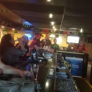 a group of people sitting at a bar