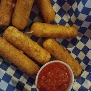 a basket of deep fried tater tots and ketchup