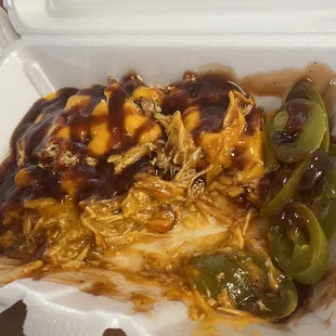 a takeout container with a chicken entree
