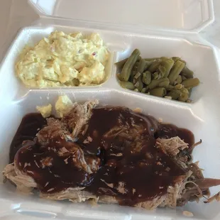 Pulled pork sandwich with potato salad and green beans