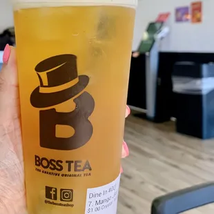 a person holding a glass of tea