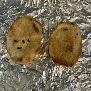 Two baguette size slices of garlic bread with each pasta dish.
