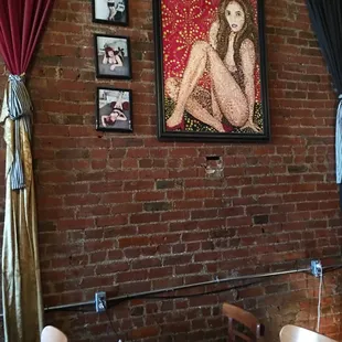 a naked woman on a brick wall