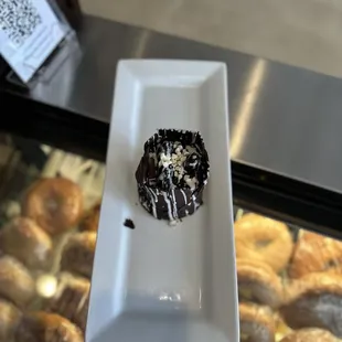 a chocolate donut on a white plate