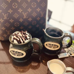 two cups of coffee and a handbag