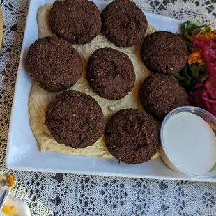 Falafel over baba ganoush and salad