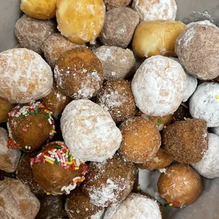 a bowl of doughnuts with sprinkles